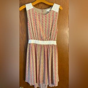 Nude colored bird dress with faux leather accents